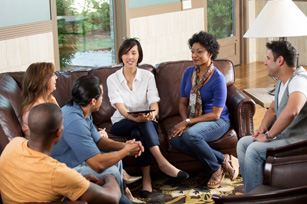 A group of people sitting in a circle having a discussion
